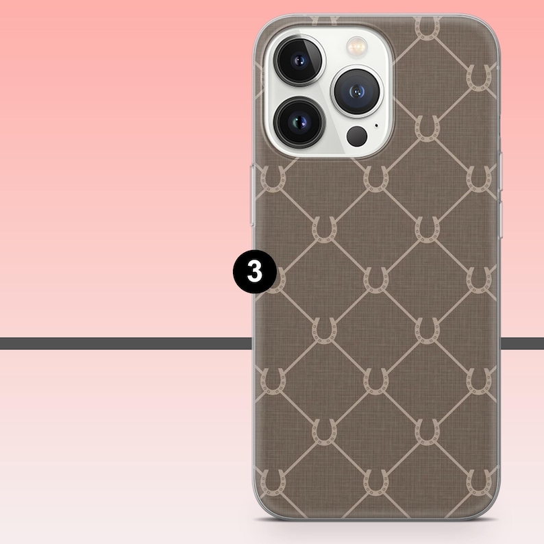 May include: A phone case with a brown background and a repeating pattern of white horseshoes. The case has a clear border and a camera cutout. The number 3 is in a black circle on the left side of the case.