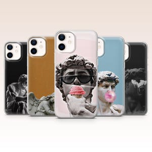 May include: A collection of phone cases featuring classical sculptures with modern elements. One case displays a sculpture wearing sunglasses and eating ice cream. Other cases have different backgrounds and images.