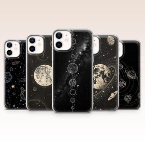 May include: Five phone cases with celestial designs. The cases feature illustrations of planets, stars, and galaxies in black and white. Each case has a different design, including a detailed moon, a starry night sky, and a solar system.