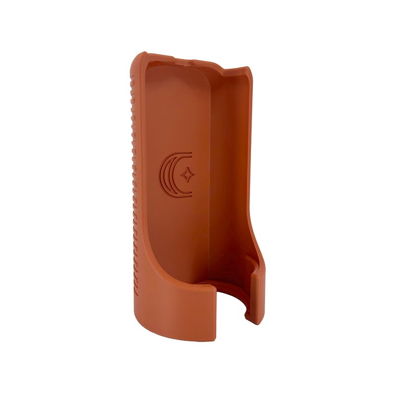 May include: A terracotta-colored, molded plastic object with a curved design. The object has a textured, ridged side and a smooth interior. A crescent moon and star logo is embossed on the front.