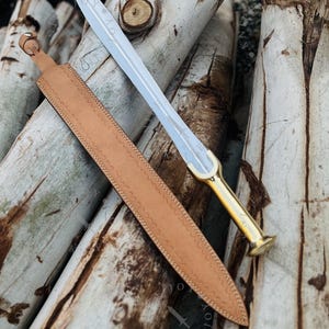 May include: A set of three ceramic mugs with a speckled, matte finish. The mugs are in shades of cream, light gray, and dark gray. Each mug has a simple, minimalist design, perfect for coffee or tea.