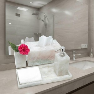 May include: Bathroom accessories set featuring a white marble tissue box, soap dispenser, tray with a folded white towel, and a vase with a red flower. The set is displayed on a countertop with a mirror in the background.