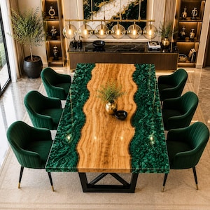 May include: A rectangular dining table featuring a natural light wood centre with wavy edges flanked by deep green resin sections, supported by a black metal base, surrounded by six dark green upholstered chairs with black legs.