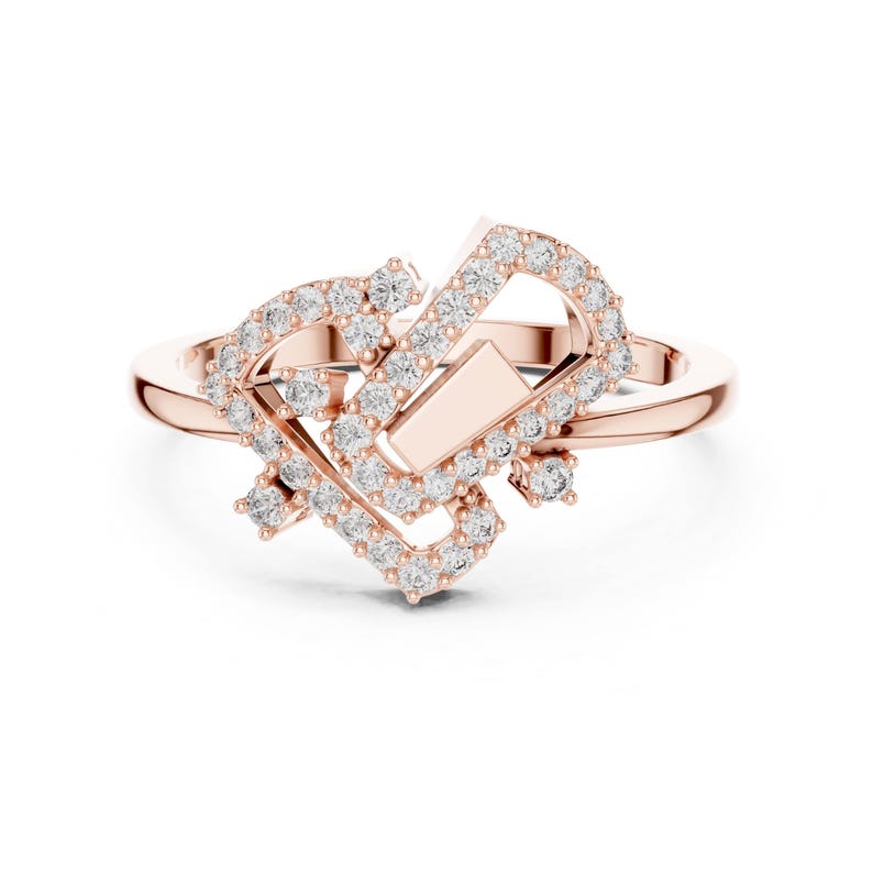 May include: Rose gold ring with a unique, geometric design. The ring features a series of interconnected shapes, embellished with numerous small, sparkling clear stones. The band is a simple, polished rose gold.