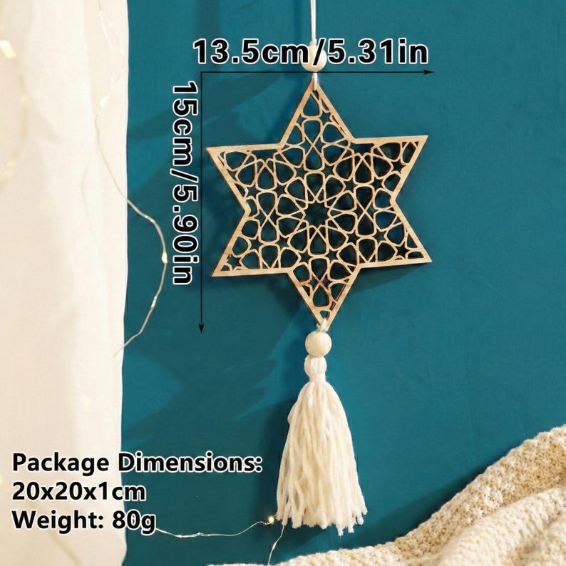 May include: A wooden star-shaped ornament with intricate cut-out patterns, measuring 5.90 inches in height and 5.31 inches wide. It features a white tassel and bead, hanging against a teal background. The star is a decorative item.