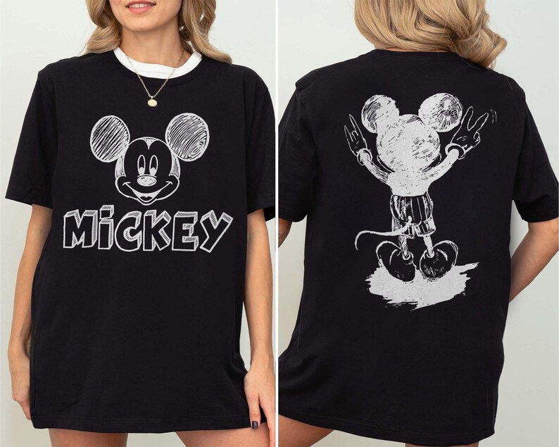 May include: Black t-shirt with a white Mickey Mouse design on the front and back. The front displays Mickey's face and the word "Mickey". The back shows Mickey with his arms raised in a peace sign.