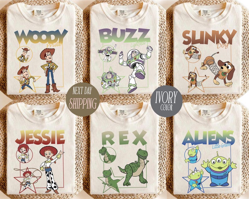 May include: Ivory-colored t-shirts featuring various Toy Story characters: Woody, Buzz, Slinky Dog, Jessie, Rex, and Aliens. Each shirt displays the character's name and a corresponding illustration. The text "Next Day Shipping" and "Ivory Color" are also visible.