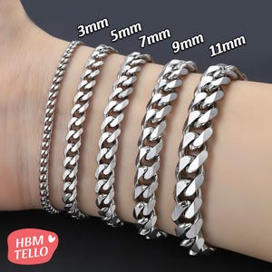 May include: A display of silver chain bracelets in varying widths: 3mm, 5mm, 7mm, 9mm, and 11mm. The bracelets are shown on a wrist, showcasing the different sizes and styles of the jewelry. The image includes the text "3mm", "5mm", "7mm", "9mm", and "11mm".