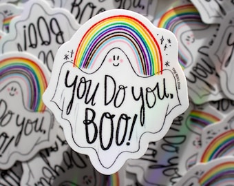 May include: A white ghost sticker with a rainbow and the text "You Do You, Boo!" The ghost has a happy face and is surrounded by other stickers with rainbows.