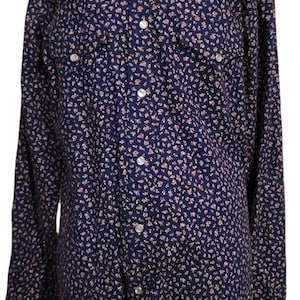 May include: A navy blue long-sleeved shirt with a white yoke and a small floral print. The shirt has a button-down collar and a single button closure at the cuff.