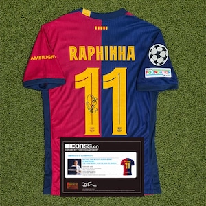 May include: A Barcelona soccer jersey, split red and blue, with the name "RAPHINHA" and the number "11" in yellow. Features a signature and the UEFA Foundation logo. Includes a certificate of authenticity from ICONSS.cn.
