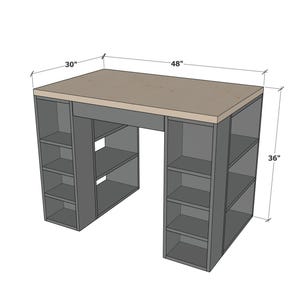May include: A gray desk with a light brown top and built-in shelving units. The desk is 48 inches wide, 30 inches deep, and 36 inches high. The shelving units are on each side of the desk.