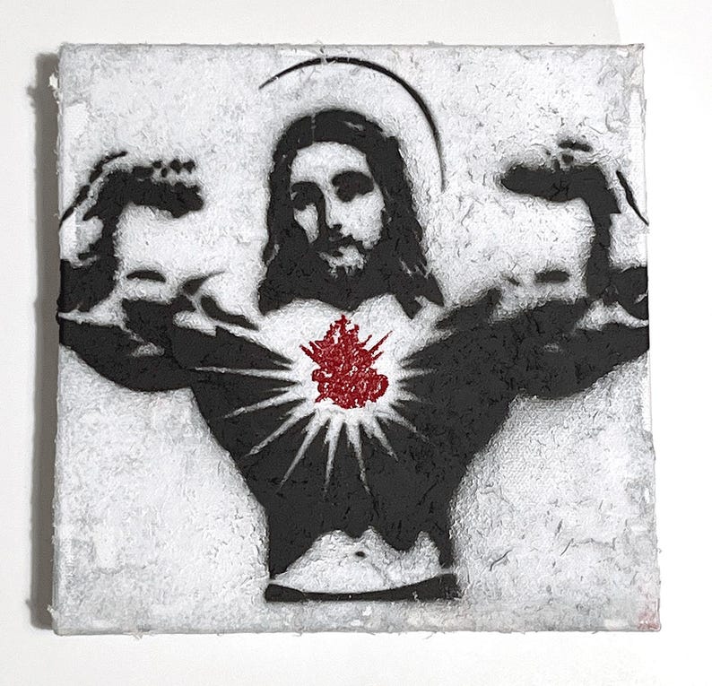 May include: A square, textured artwork featuring a black and white stencil of a muscular figure with a halo, resembling Jesus. A red, stylized heart is at the center of the figure's chest. The artwork has a distressed, aged appearance.