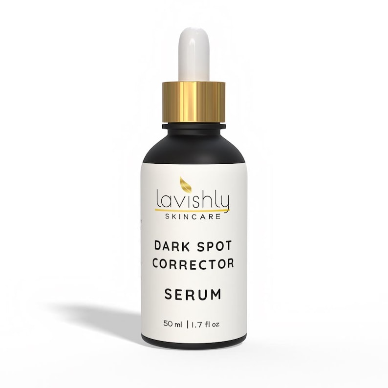 May include: A black and white skincare serum bottle with a gold cap and dropper. The label reads "Lavishly Skincare" and "Dark Spot Corrector Serum". The bottle contains 50 ml / 1.7 fl oz of product.