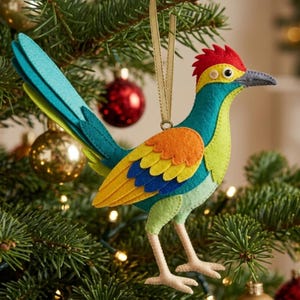 May include: A felt roadrunner ornament featuring a vibrant colour palette of teal, lime green, orange, and yellow. The bird has a red crest, a grey beak, and light beige legs, suspended by a thin gold ribbon for hanging on a Christmas tree.