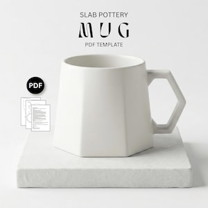 May include: A white, geometric mug with a hexagonal body and handle, sitting on a white square base. The mug is labeled "SLAB POTTERY MUG PDF TEMPLATE". A PDF icon and documents are to the left of the mug.