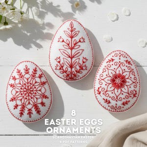 May include: Three white Easter egg ornaments with red embroidered floral designs. The eggs have intricate patterns and are displayed on a white surface. Text on the image reads "8 Easter Eggs Ornaments Scandinavian Easter 8 PDF Patterns."