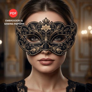 May include: A black masquerade mask featuring intricate gold embroidery in a floral and vine pattern. The mask covers the eye area and includes text that reads PDF EMBROIDERY & SEWING PATTERN. The design is symmetrical with ornate detailing.