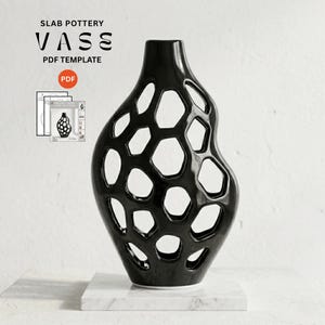 May include: A glossy black ceramic vase with an openwork honeycomb lattice structure. The text SLAB POTTERY VASE PDF TEMPLATE is visible, along with a small PDF icon and a graphic showing the template pages for this sculptural vessel design.