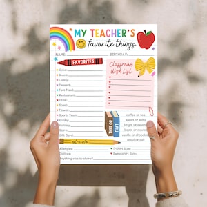 May include: A colorful printable worksheet titled "My Teacher's Favorite Things" with rainbow, apple, and pencil graphics. Includes sections for favorites, a classroom wish list, and "this or that" choices. Held by hands.