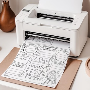 May include: A white printer producing a black and white "My Dad" activity sheet. The sheet has spaces to write about Dad's favourite food, job, and other details. The words "I Love You!" and "#1 Dad" are also printed on the sheet.