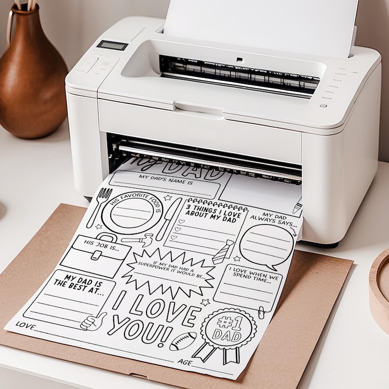 May include: A white printer producing a black and white "My Dad" activity sheet. The sheet has spaces to write about Dad's favourite food, job, and other details. The words "I Love You!" and "#1 Dad" are also printed on the sheet.