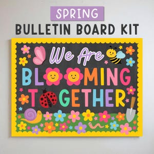 May include: A spring bulletin board kit with a black background and a yellow border. The board features the text "We Are Blooming Together" in colourful letters, along with illustrations of flowers, a butterfly, a ladybug, a bee, and a snail.