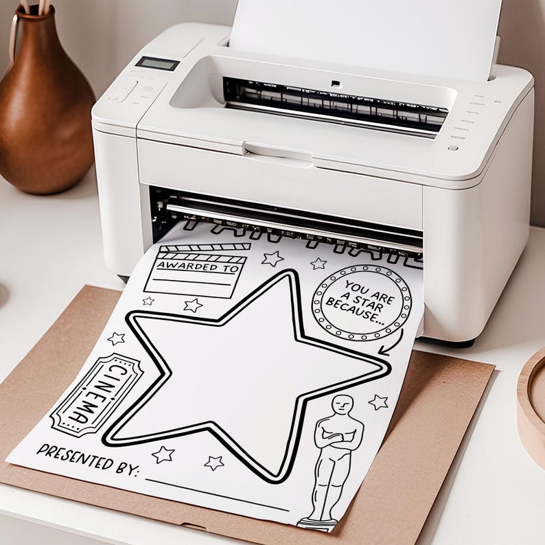 May include: A white printer printing a black and white award certificate. The certificate features a large star, film reel, ticket, and Oscar statue illustrations. Text includes "Awarded To", "Cinema", and "You Are A Star Because..."