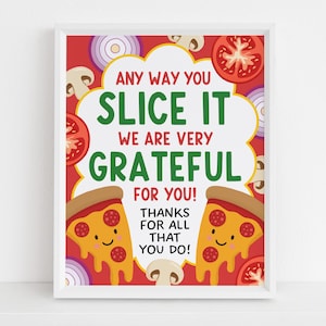 May include: A framed print with a red background and a white border. The print features the text "ANY WAY YOU SLICE IT WE ARE VERY GRATEFUL FOR YOU! THANKS FOR ALL THAT YOU DO!" with pizza slices and vegetables.