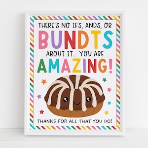 Può includere: Stampa incorniciata con sfondo bianco e testo colorato: "THERE'S NO IFS, ANDS, OR BUNDTS ABOUT IT... YOU ARE AMAZING!" Al centro, una torta a ciambella a fumetti con un volto sorridente. La cornice ha un bordo arcobaleno.