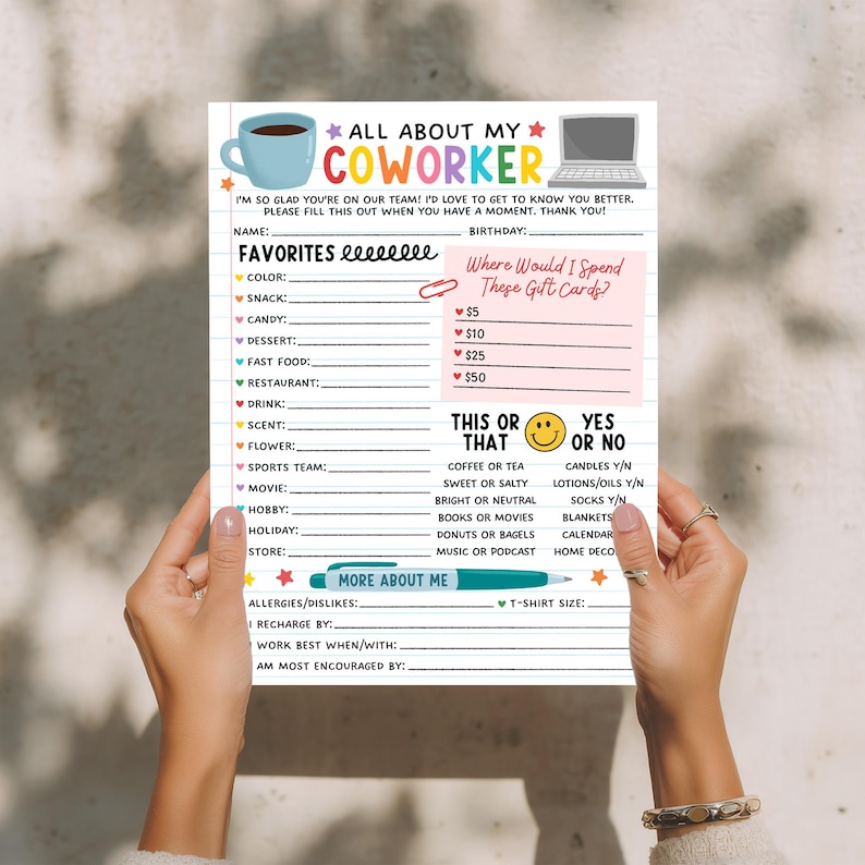 May include: A white fill-in-the-blank questionnaire titled "All About My Coworker" with sections for favorites, gift card preferences, and "This or That" choices. The sheet is held by a person.