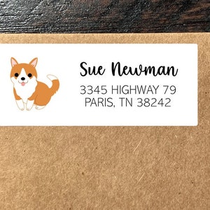 May include: White return address label with a cartoon image of a corgi dog. The text on the label reads "Sue Newman, 3345 Highway 79, Paris, TN 38242".