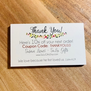 May include: White thank you card with pink floral border. Text reads: "Thank You! Here's 10% off your next order! Coupon Code: THANKYOU10 Susan Leuci - SuLu Gifts www.SuLuGifts.Etsy.com We love because he first loved us. 1 John 4:19"