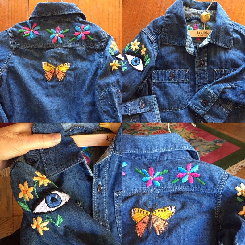 May include: A denim shirt with embroidered butterflies, flowers, and eyes. The shirt has a label that says "kushie".