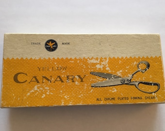 May include: A yellow box with the words "Yellow Canary" and "All Chrome Plated Pinking Shears" printed on it. The box has a small bird logo with the words "Trade Mark" above it.