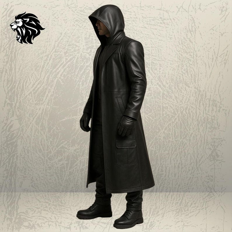 May include: A long black leather coat with a hood, worn with matching black leather gloves, black trousers, and black boots. The coat features a structured collar, long sleeves, and a large rectangular pocket on the lower front side of the garment.