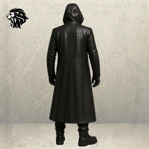 May include: A long black leather coat with a hood, worn with matching black gloves, black trousers, and black boots. The coat features a smooth finish and visible seam detailing along the back. A black lion head logo is positioned in the top left.