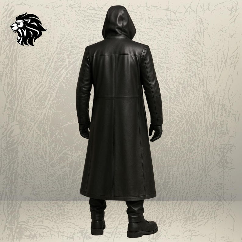 May include: A long black leather coat with a hood, worn with matching black gloves, black trousers, and black boots. The coat features a smooth finish and visible seam detailing along the back. A black lion head logo is positioned in the top left.