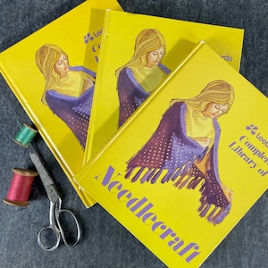 May include: Three yellow books with a woman on the cover of each. The books are titled "Lee's Complete Library of Needlecraft".