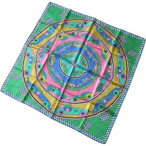 May include: A square silk scarf featuring a vibrant concentric circular pattern. The design includes stylized vintage cars in shades of green, blue, and pink, set against a bright green background with checkered flag motifs at each corner.