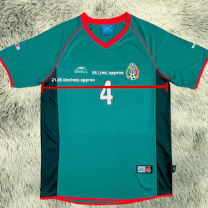 May include: A green soccer jersey with red trim, a V-neck, and short sleeves. The jersey features the number 4 in white, a team emblem, and the text "Atletico 55 (cm) approx 21.65 (inches) approx".