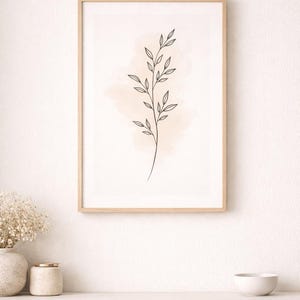 May include: A framed botanical print with a minimalist line drawing of a plant stem and leaves. The artwork is set against a soft peach-coloured watercolour wash, in a light wood frame, displayed on a white wall.