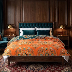 May include: A bed featuring a wooden frame, a tufted teal headboard, and a bright orange blanket with a repeating floral pattern. The bedding includes white pillows and two teal accent pillows, all arranged on a dark wood bed frame.