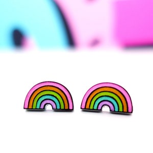 May include: A pair of rainbow-colored stud earrings. The earrings are shaped like rainbows with pink, orange, yellow, green, blue, and purple stripes.
