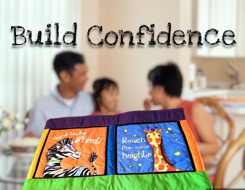 Child and parents at dinner table with image of bright placemat with colourful animals and words of encouragement in the foreground.