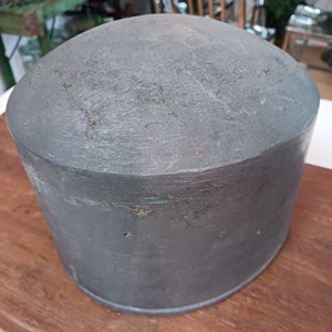 May include: A large, round, gray concrete planter. The planter is smooth and has a slightly textured surface.