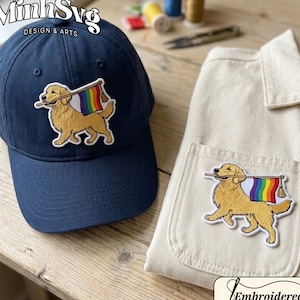 May include: Navy blue baseball cap and cream-colored shirt with embroidered patches. The patches depict a golden retriever holding a rainbow flag. The cap has the text "MinhSvg DESIGN & ARTS". The shirt has a pocket with the same embroidered patch. The word "Embroidered" is also visible.