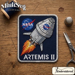 May include: Embroidered patch with the NASA logo and an Artemis II spacecraft illustration. The patch has a navy blue background and a white border. The spacecraft is depicted with flames. The text "ARTEMIS II" is at the bottom of the patch.