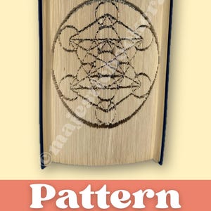 May include: A book with pages folded to create a geometric design. The design is a complex pattern within a circle. The book has a dark blue spine and the text "Pattern to craft your own" is at the bottom. Digital pattern (PDF) - Instant Download.