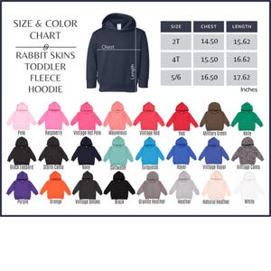 May include: A size and color chart for Rabbit Skins toddler fleece hoodies. The chart displays a navy blue hoodie with chest and length measurements in inches. Various hoodie colors are shown, including pink, red, and black.